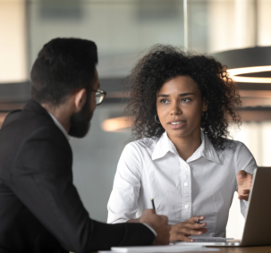 African American businesswoman and colleague discussing project